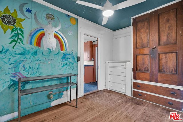 a view of an empty room with a windows and wooden door