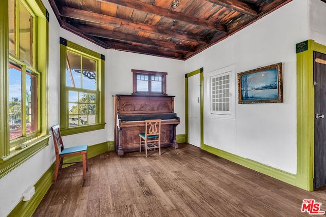 a room with wooden floor and furniture