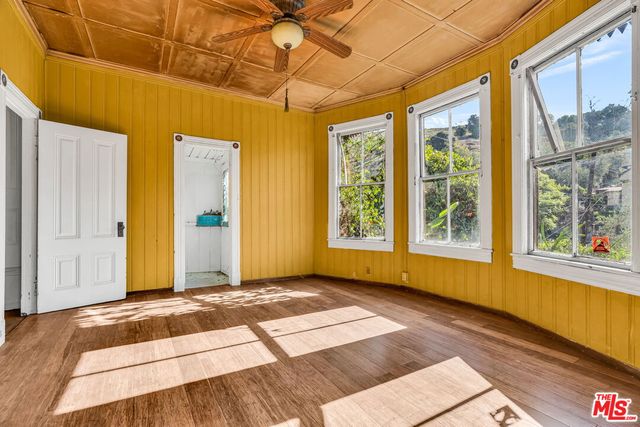 a view of a room with wooden floor and door