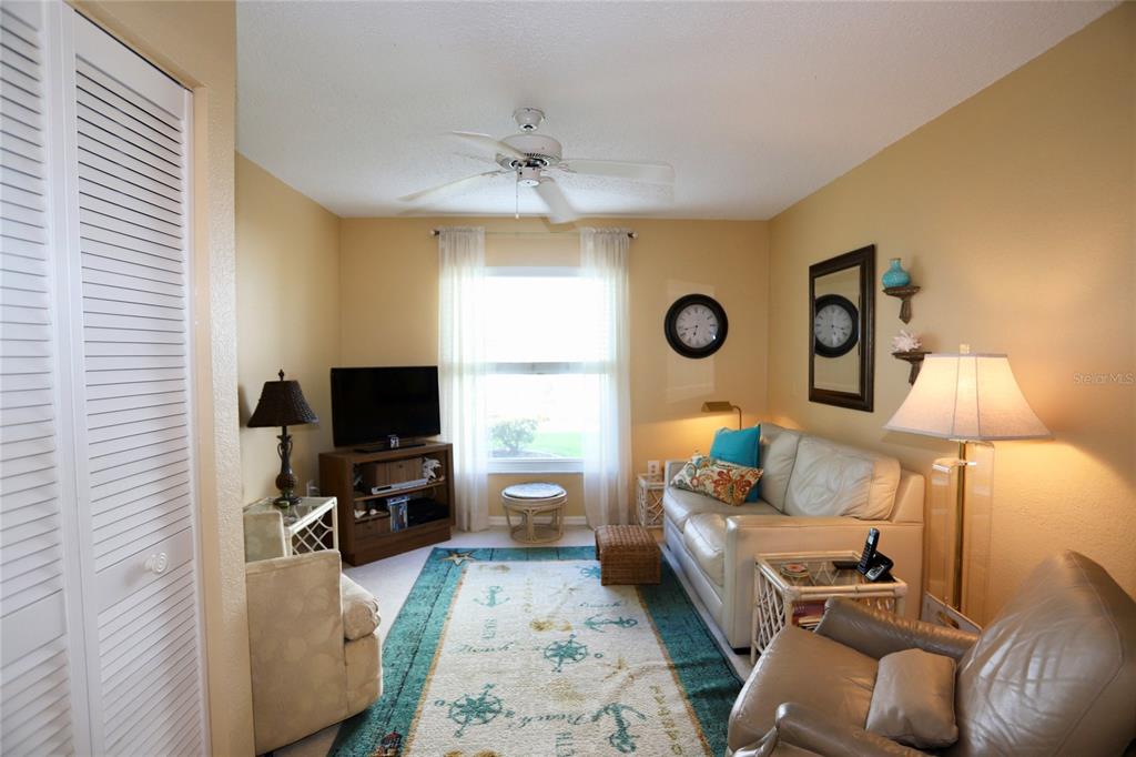 6707 Stone River Road, Unit 101 Bradenton, FL 34203 - Photo 14 of 34 a living room with furniture and a flat screen tv