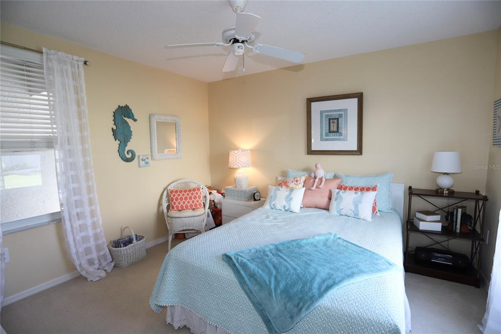 6707 Stone River Road, Unit 101 Bradenton, FL 34203 - Photo 17 of 34 a bedroom with a bed and a lamp