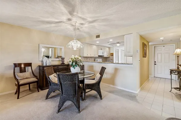 a living room with furniture a chandelier and a flat screen tv
