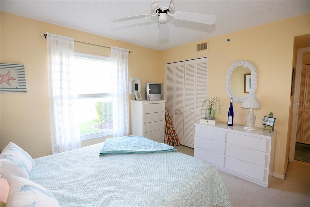 6707 Stone River Road, Unit 101 Bradenton, FL 34203 - Photo 18 of 34 a bedroom with a bed and a dresser