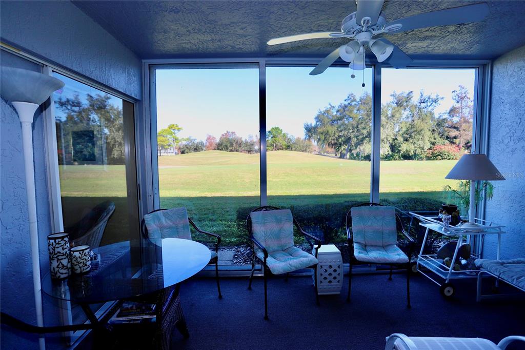 6707 Stone River Road, Unit 101 Bradenton, FL 34203 - Photo 21 of 34 a outdoor living space with furniture and a floor to ceiling window