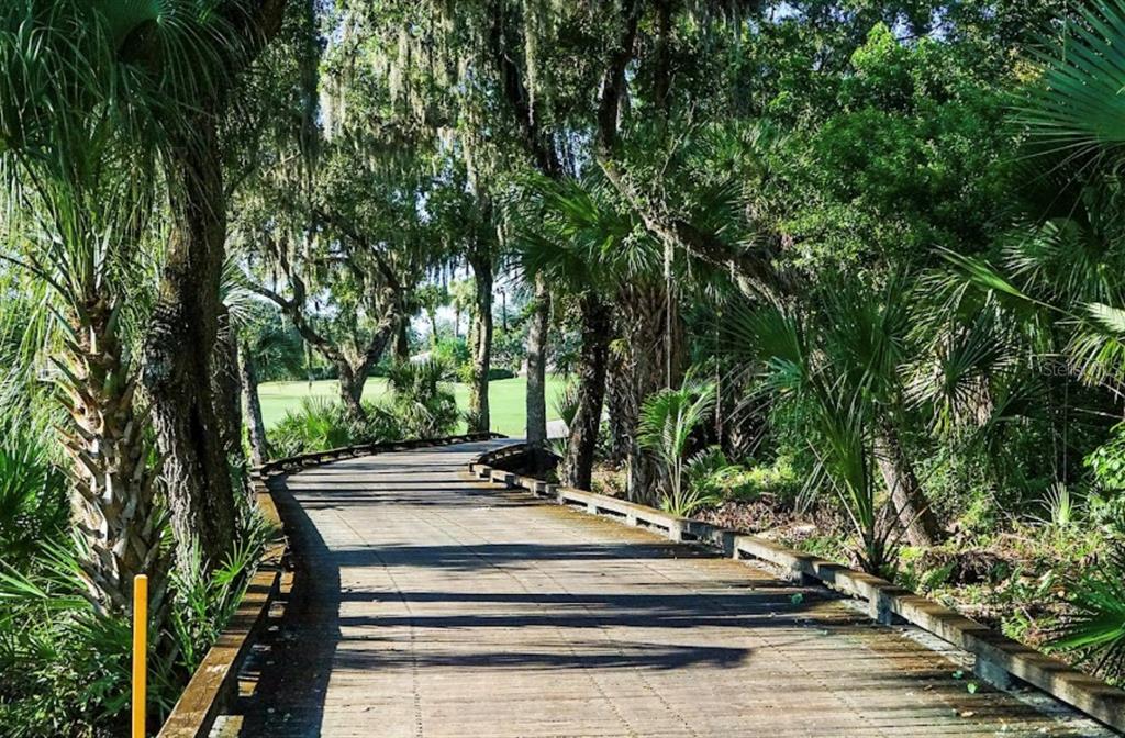 6707 Stone River Road, Unit 101 Bradenton, FL 34203 - Photo 25 of 34 a view of bench sitting in middle of a park