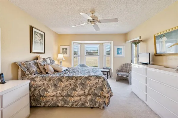 an aerial view of residential houses with outdoor space and ocean view