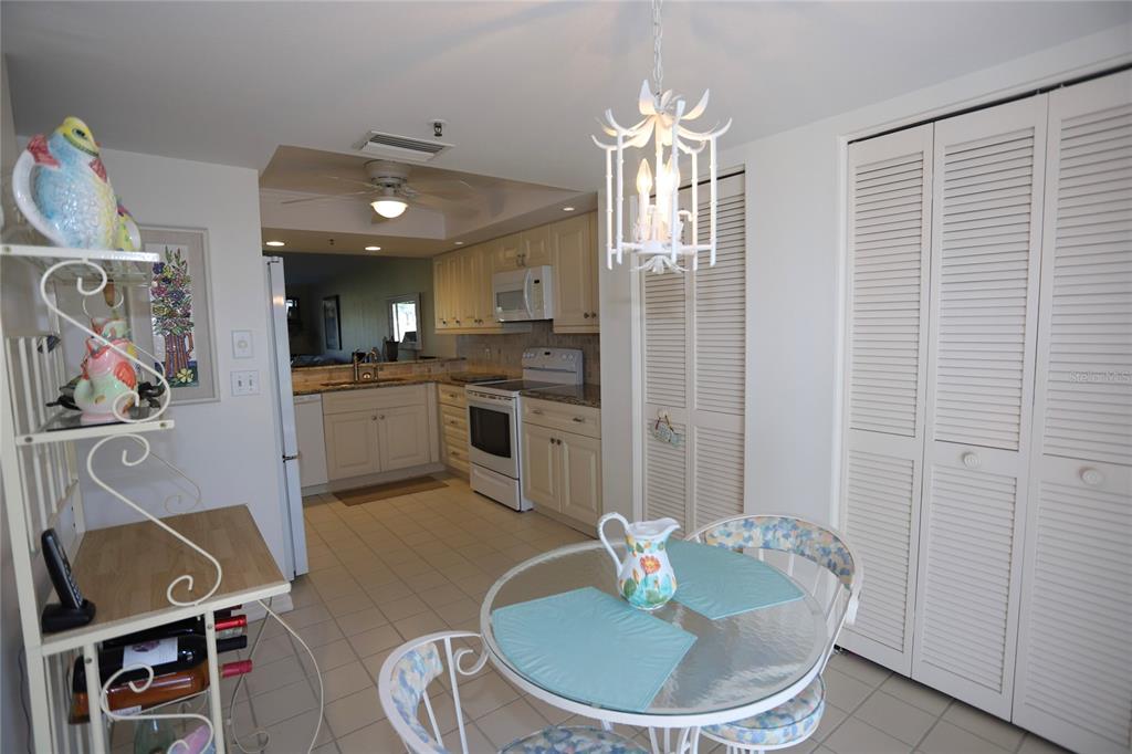 6707 Stone River Road, Unit 101 Bradenton, FL 34203 - Photo 4 of 34 a kitchen with stainless steel appliances granite countertop a sink and a refrigerator