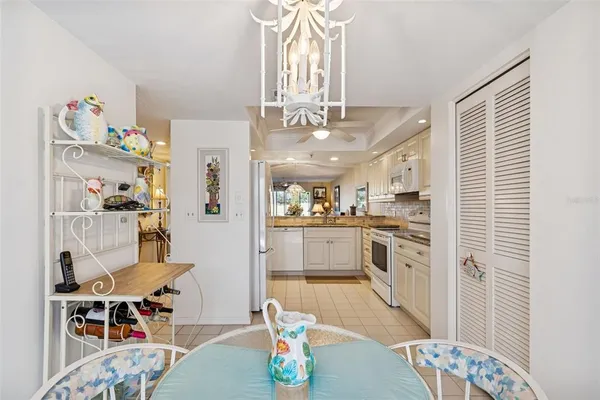 a kitchen with white cabinets and white appliances