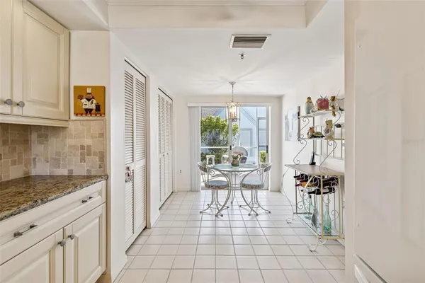 a kitchen with white cabinets appliances and a sink