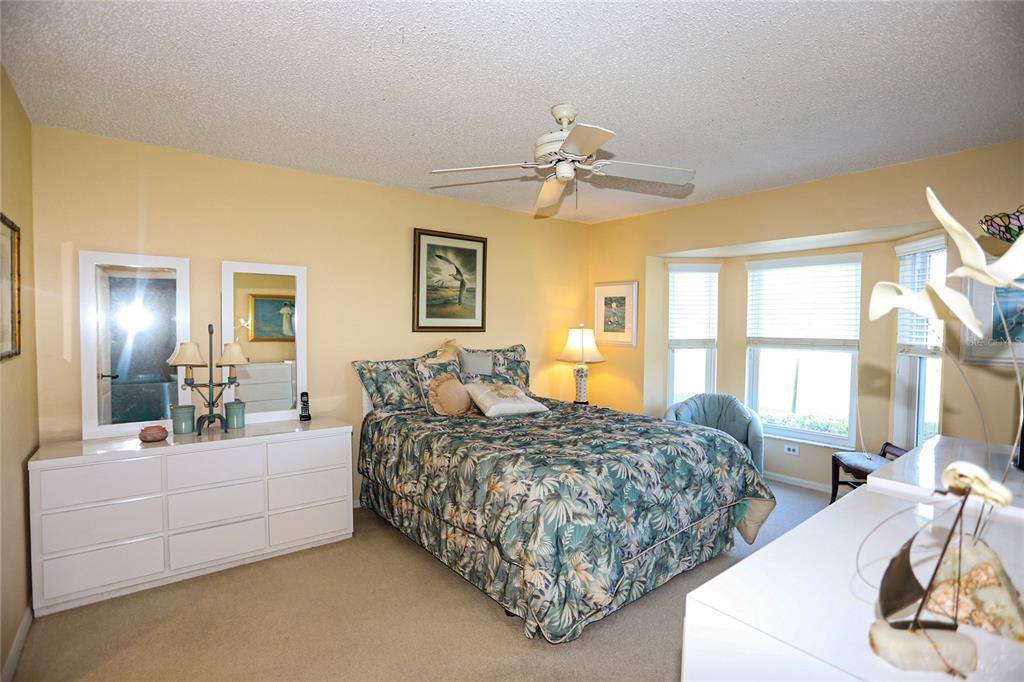 6707 Stone River Road, Unit 101 Bradenton, FL 34203 - Photo 10 of 34 a bedroom with two beds and large windows