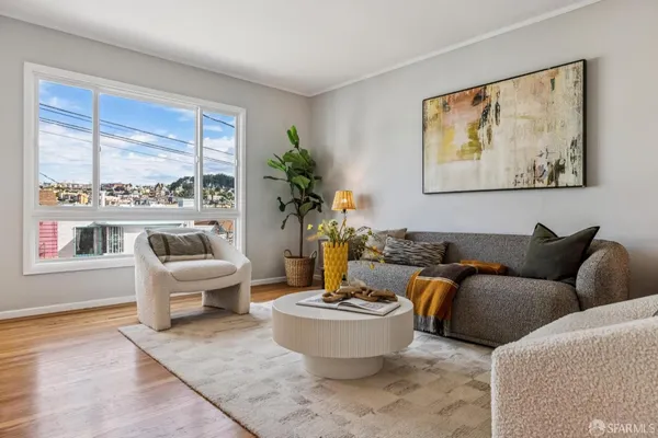 a living room with furniture and a potted plant