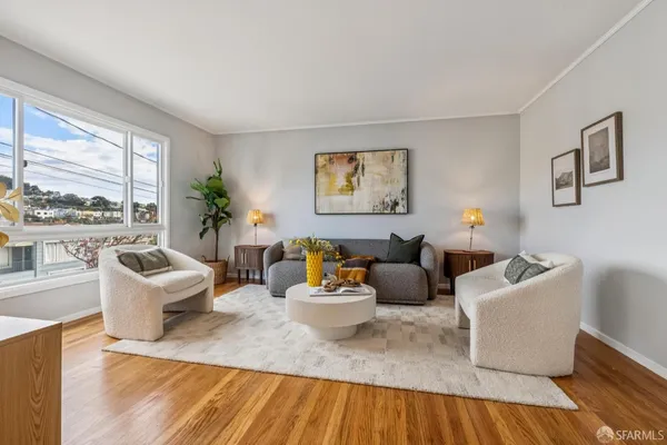 a living room with furniture and a mirror