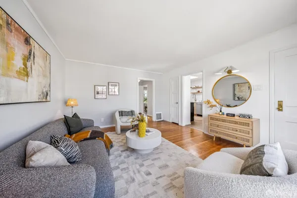 a dining room with stainless steel appliances a dining table and chairs