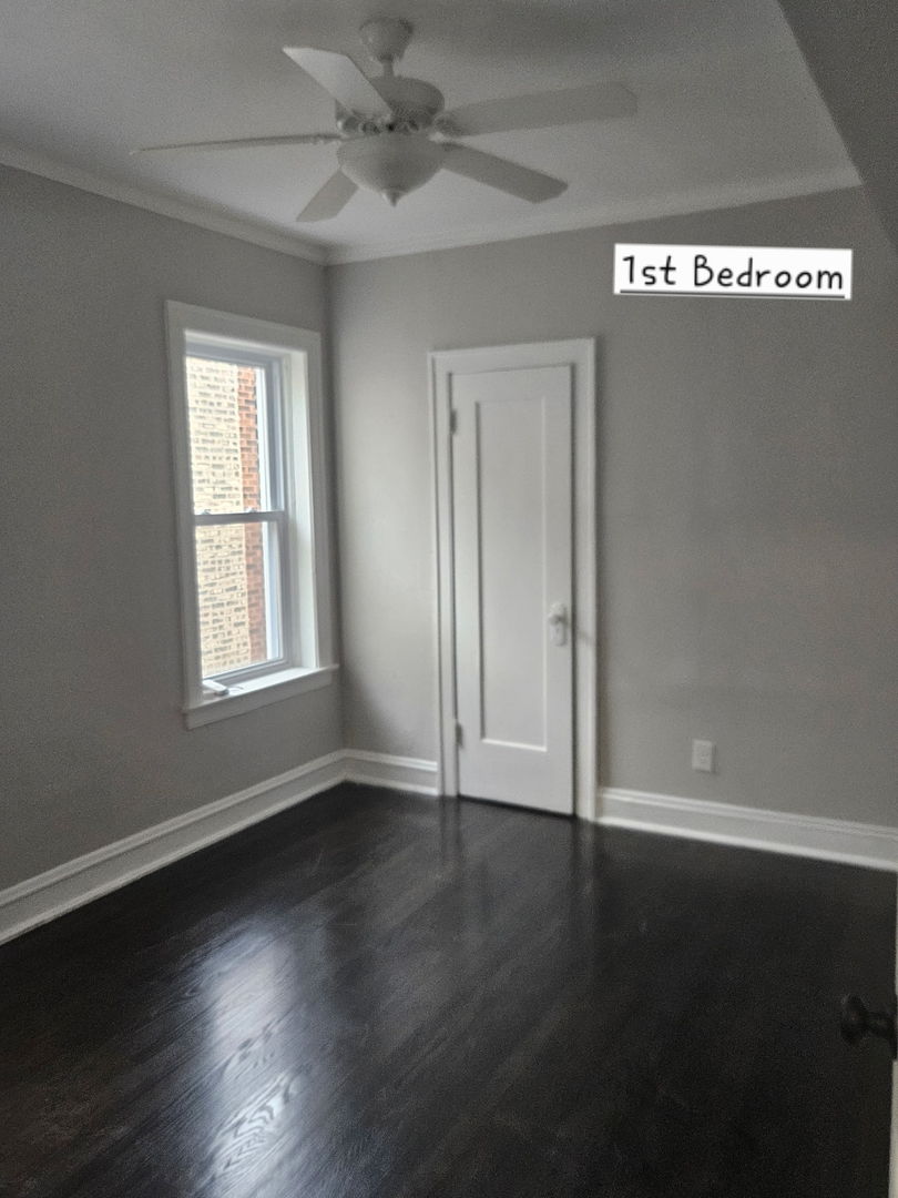 8309 South Throop Street, Unit 3 Chicago, IL 60620 - Photo 2 of 15 a view of an empty room with wooden floor and a window