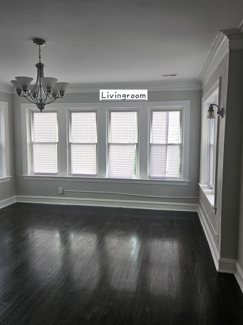 8309 South Throop Street, Unit 3 Chicago, IL 60620 - Photo 4 of 15 a view of an empty room with wooden floor and a window