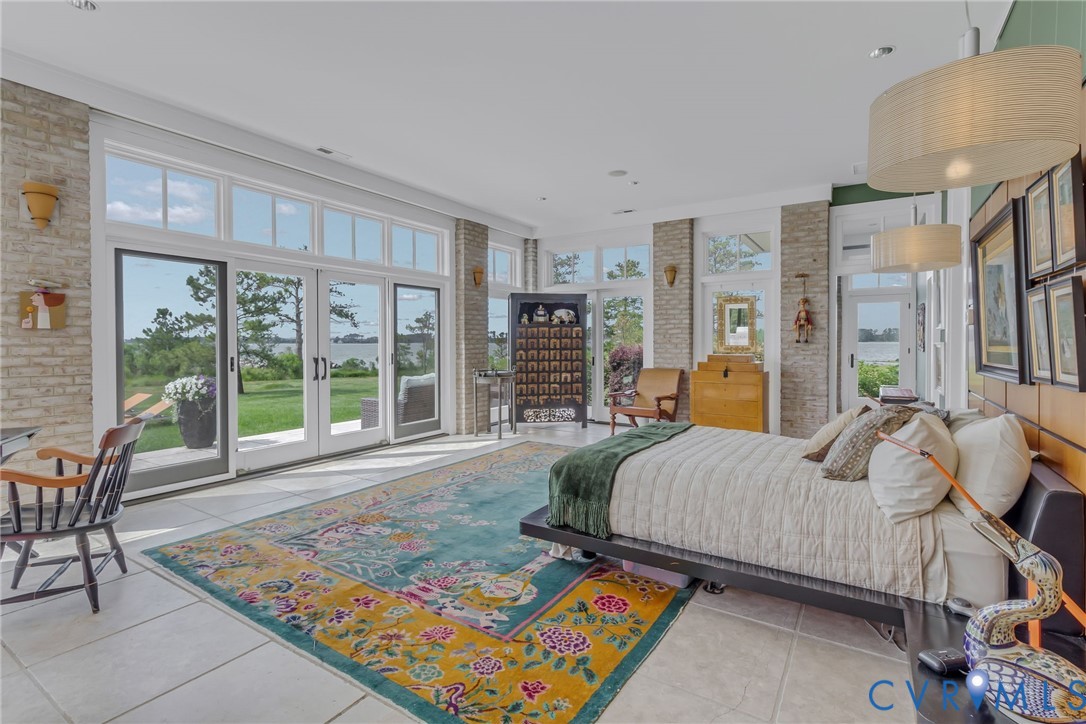 1071 Gum Thicket Road Gwynn, VA 23076 - Photo 24 of 53 a spacious bedroom with a bed and glass windows