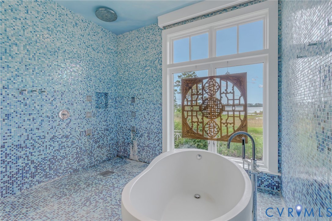 1071 Gum Thicket Road Gwynn, VA 23076 - Photo 26 of 53 a bathroom with a tub sink and shower