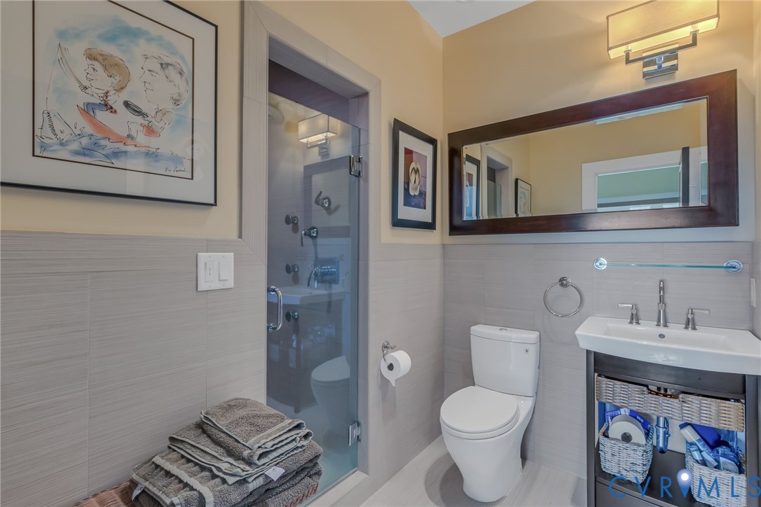 1071 Gum Thicket Road Gwynn, VA 23076 - Photo 32 of 53 a bathroom with a toilet a sink and a shower curtain