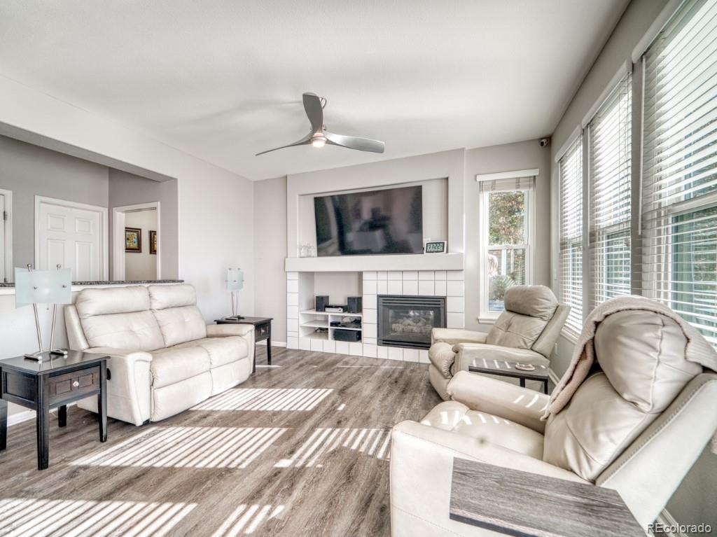 1864 Mountain Maple Avenue Highlands Ranch, CO 80129 - Photo 14 of 35 a living room with furniture a fireplace and a flat screen tv