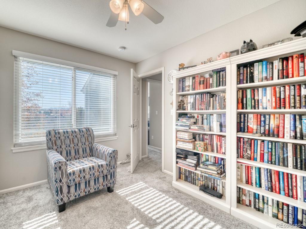 1864 Mountain Maple Avenue Highlands Ranch, CO 80129 - Photo 16 of 35 a living room with furniture and a book shelf