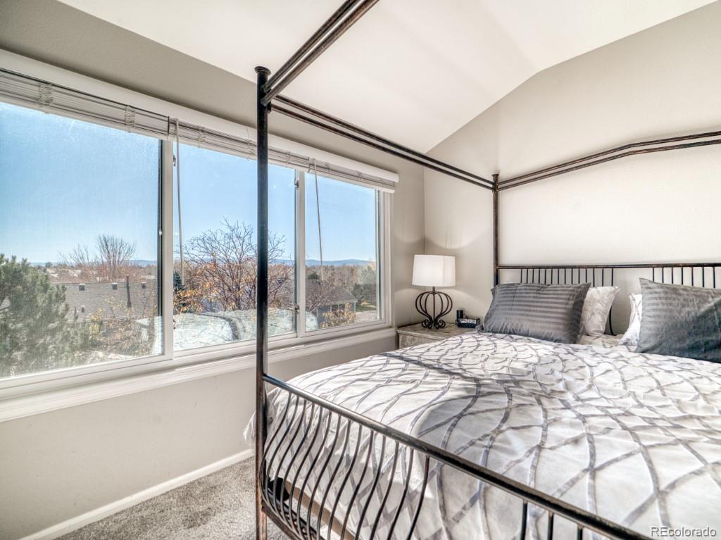 1864 Mountain Maple Avenue Highlands Ranch, CO 80129 - Photo 19 of 35 a bedroom with a large bed and a large window with outer view