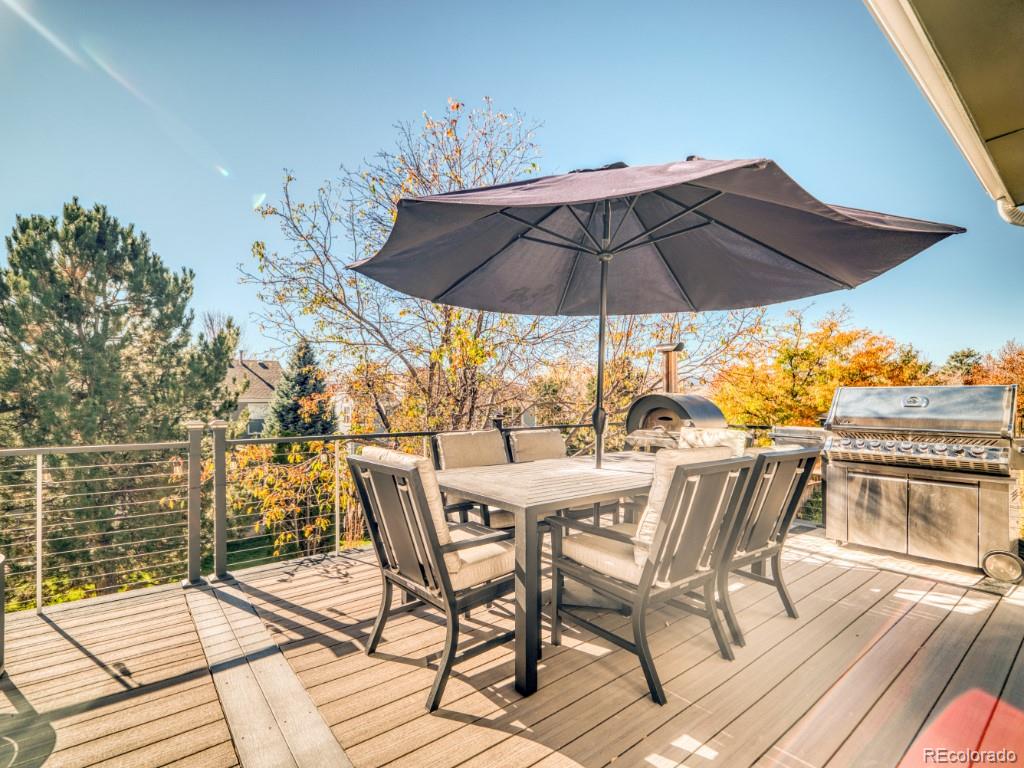 1864 Mountain Maple Avenue Highlands Ranch, CO 80129 - Photo 2 of 35 a view of a terrace with furniture and umbrella