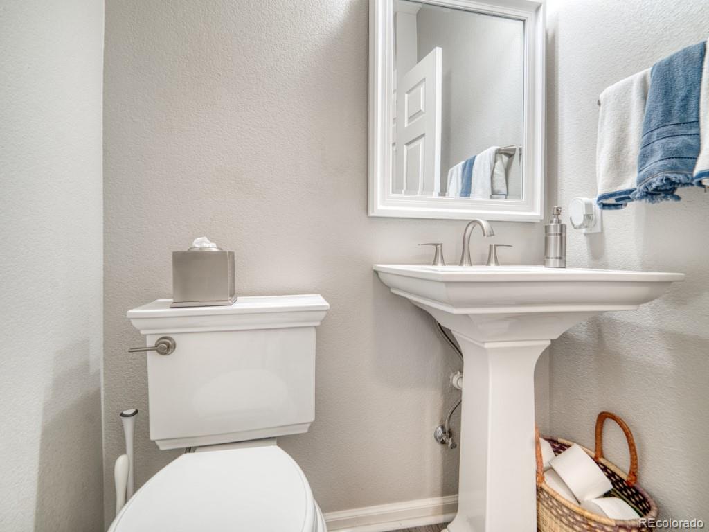 1864 Mountain Maple Avenue Highlands Ranch, CO 80129 - Photo 23 of 35 a bathroom with a sink mirror and toilet