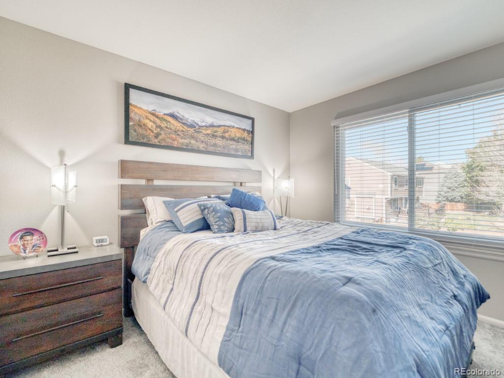 1864 Mountain Maple Avenue Highlands Ranch, CO 80129 - Photo 24 of 35 a bedroom with a bed and a large window