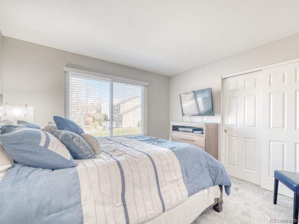 1864 Mountain Maple Avenue Highlands Ranch, CO 80129 - Photo 26 of 35 a bedroom with a bed a table and chair
