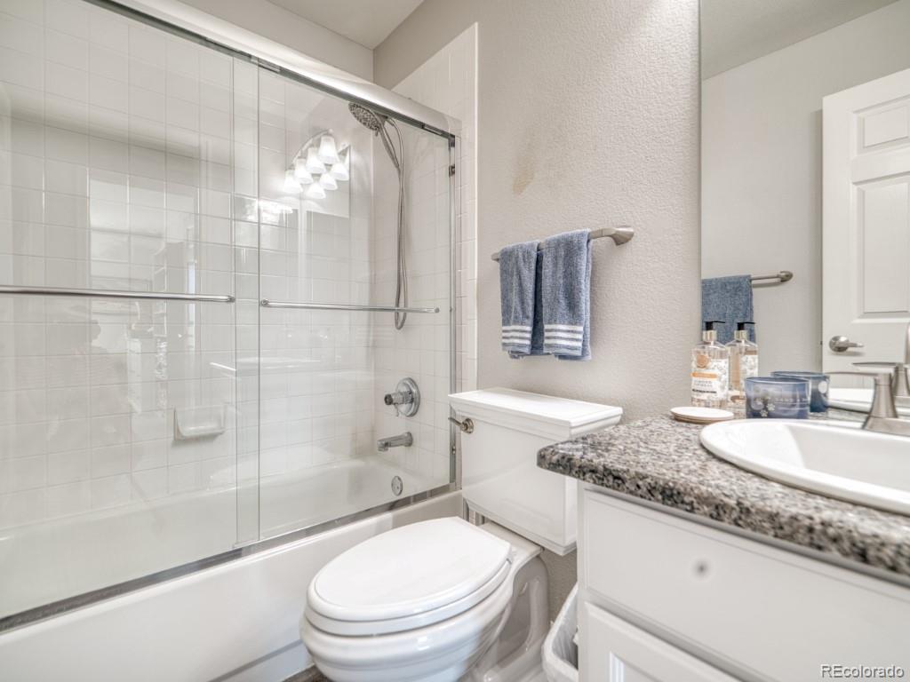 1864 Mountain Maple Avenue Highlands Ranch, CO 80129 - Photo 27 of 35 a bathroom with a granite countertop sink toilet and shower
