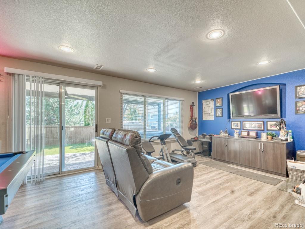 1864 Mountain Maple Avenue Highlands Ranch, CO 80129 - Photo 30 of 35 a living room with furniture and a flat screen tv