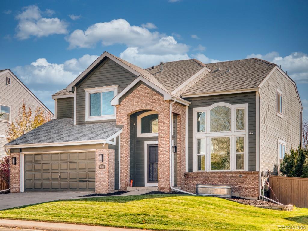 1864 Mountain Maple Avenue Highlands Ranch, CO 80129 - Photo 9 of 35 a front view of a house with a yard