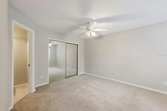 an empty room with a fan and a fan