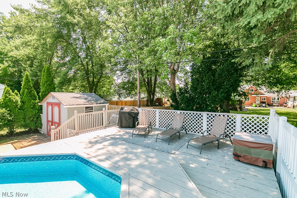 1314 Mayfield Ridge Road Cleveland, OH 44124 - Photo 36 of 40 View of swimming pool with a wooden deck and a storage shed