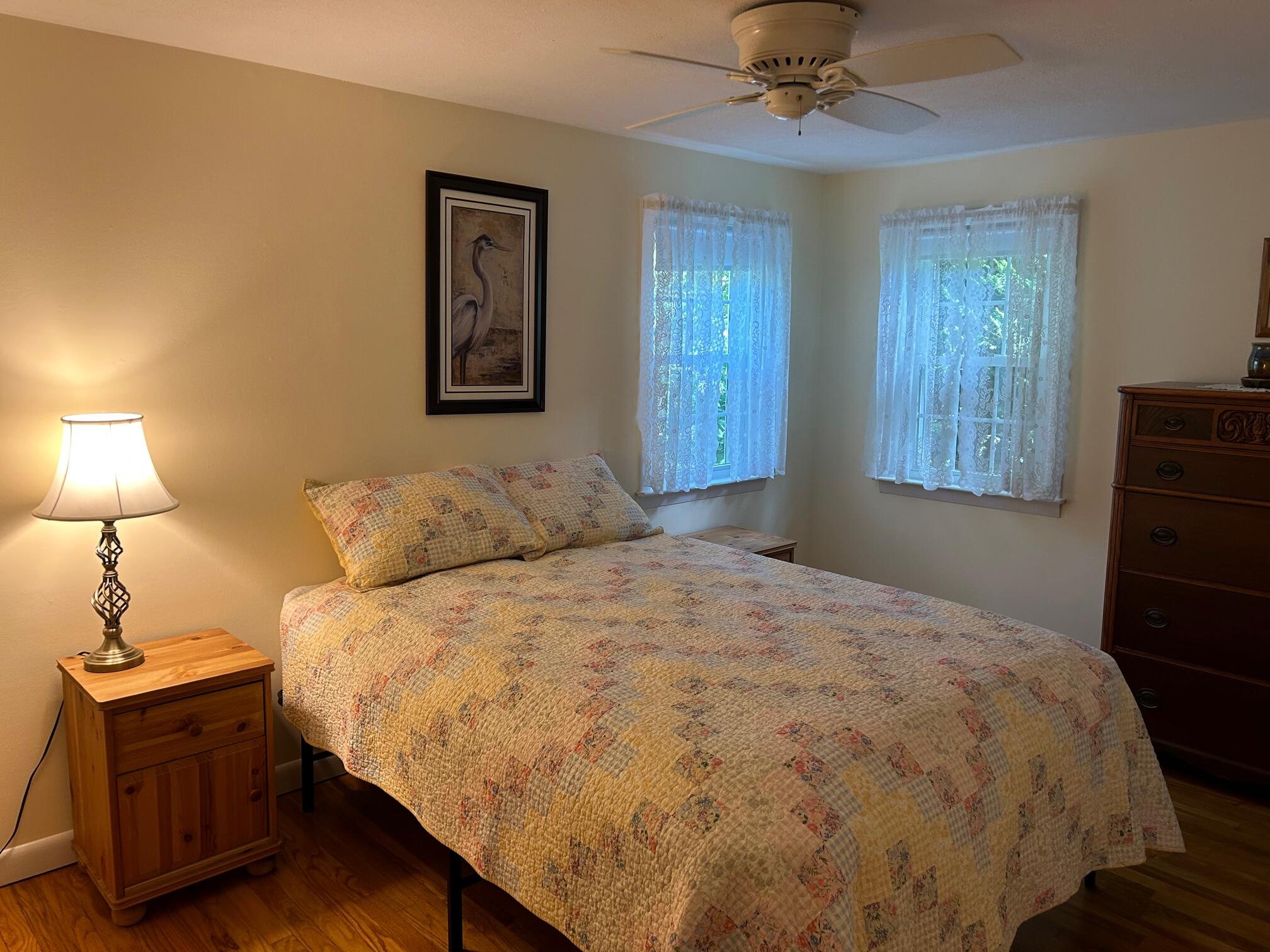 5 Acorn Road Dennis, MA 02638 - Photo 12 of 27 a bedroom with a bed and a lamp