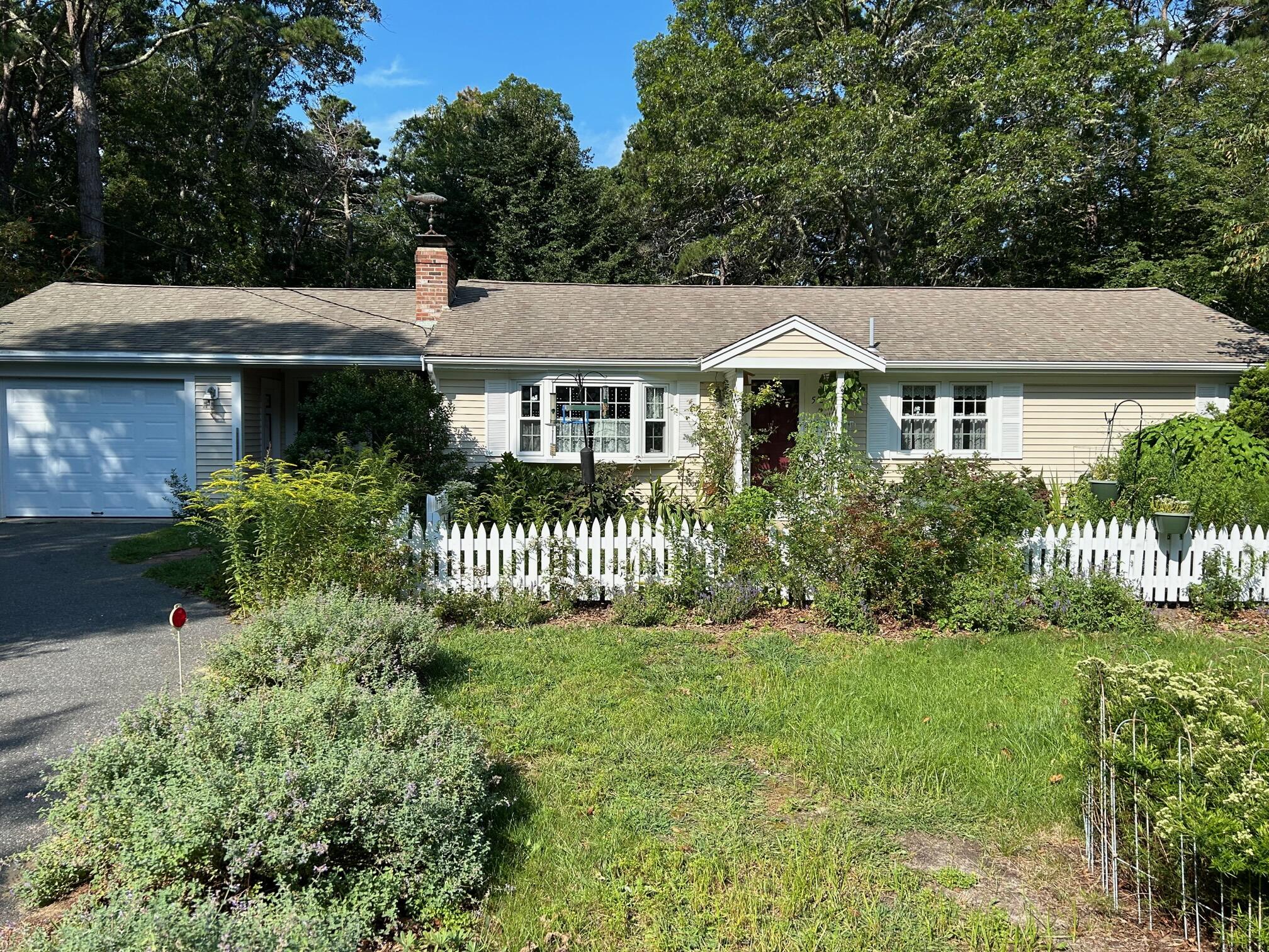 5 Acorn Road Dennis, MA 02638 - Photo 19 of 27 front view of a house with a garden