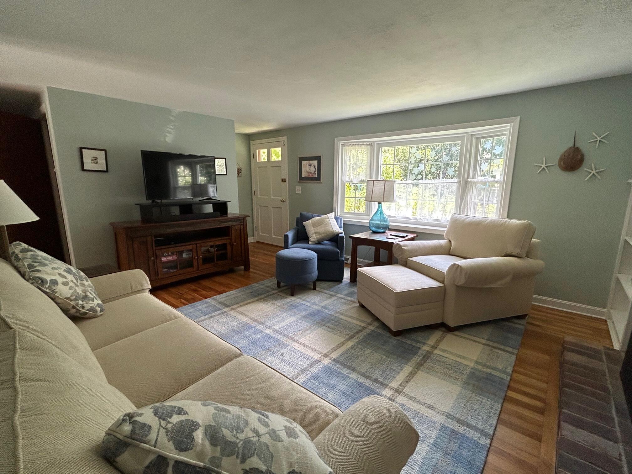 5 Acorn Road Dennis, MA 02638 - Photo 2 of 27 a living room with furniture and a flat screen tv