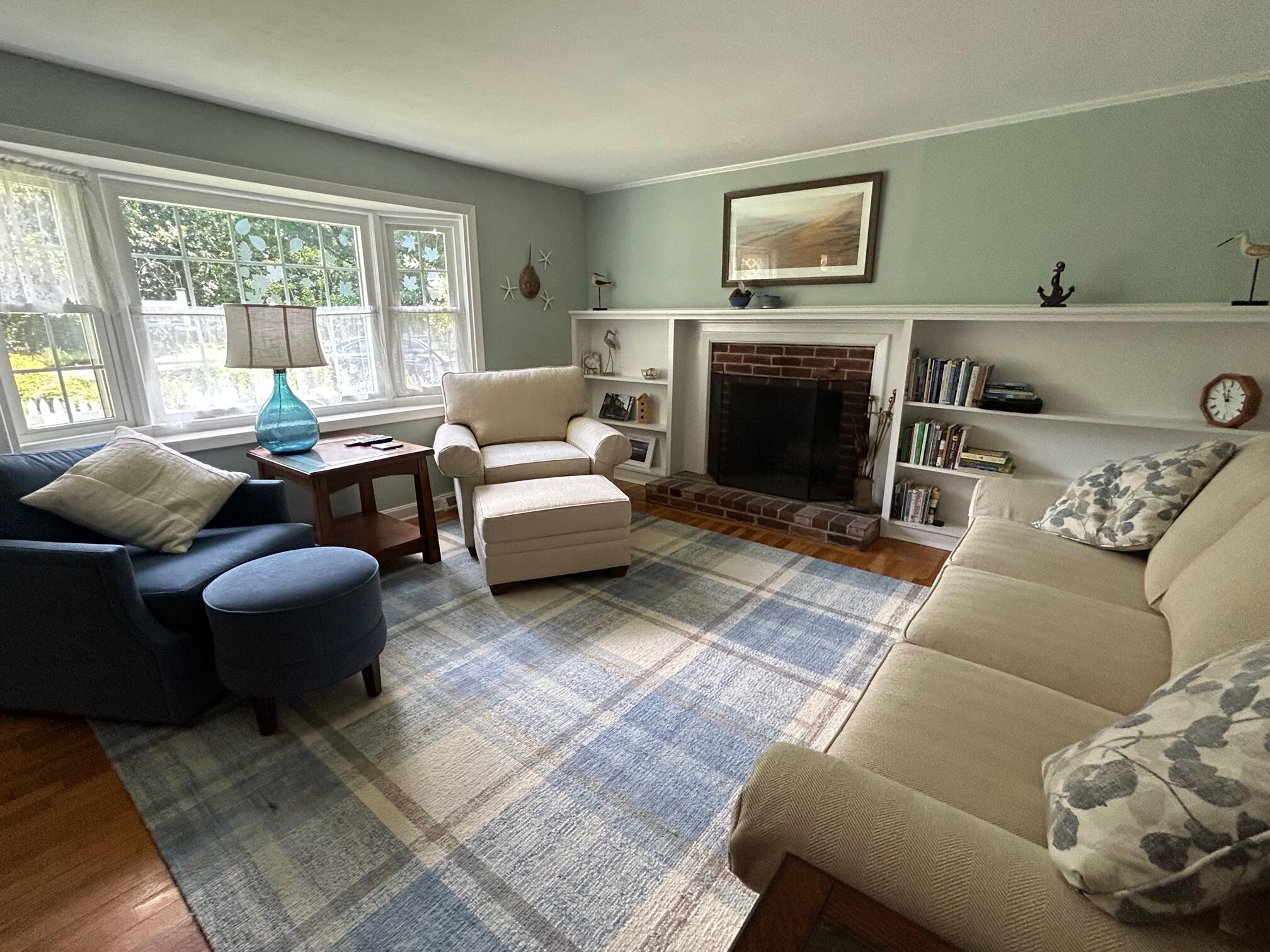 5 Acorn Road Dennis, MA 02638 - Photo 3 of 27 a living room with furniture and a fireplace