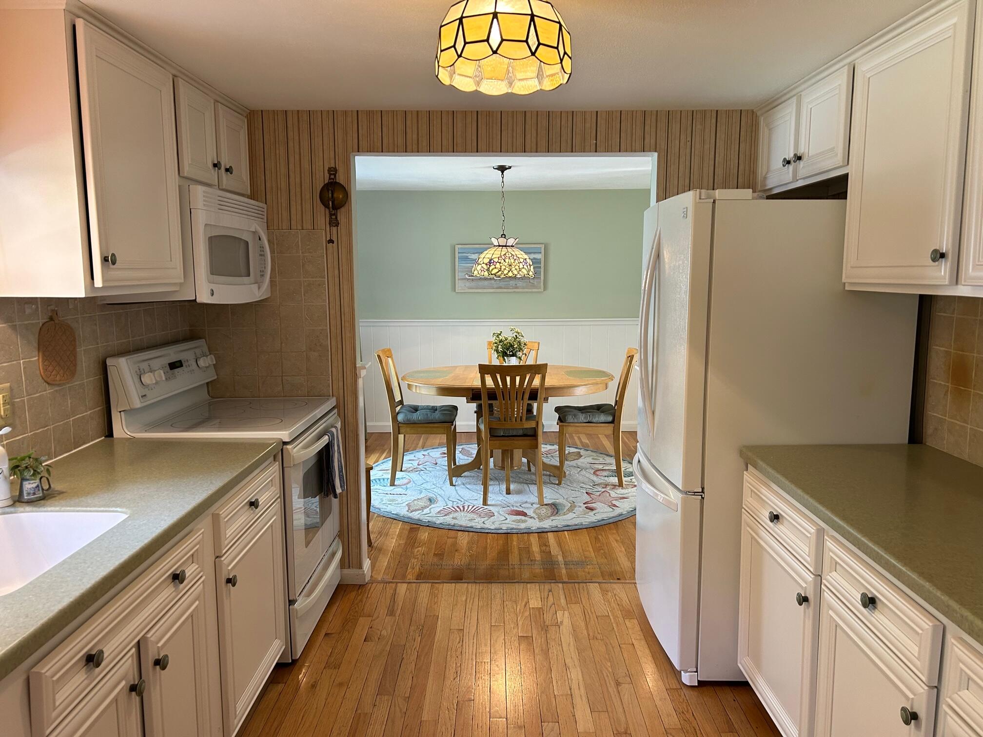 5 Acorn Road Dennis, MA 02638 - Photo 4 of 27 a kitchen with stainless steel appliances granite countertop a sink dishwasher and a stove next to a refrigerator