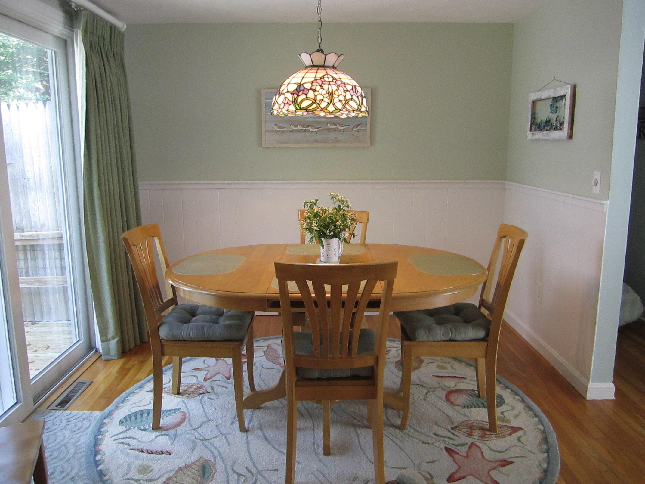 5 Acorn Road Dennis, MA 02638 - Photo 6 of 27 a view of a dining room with furniture a chandelier and wooden floor
