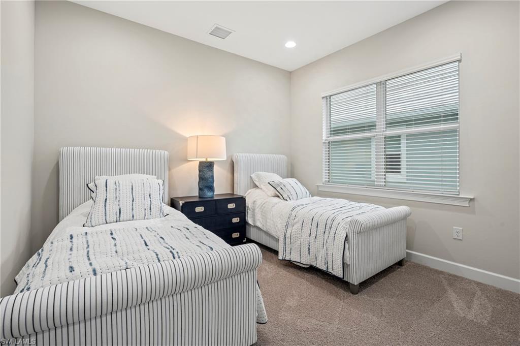 8795 Calypso Court Naples, FL 34113 - Photo 15 of 49 a bedroom with two beds and a window