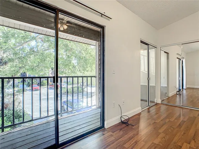a view of a room with wooden floor and a window