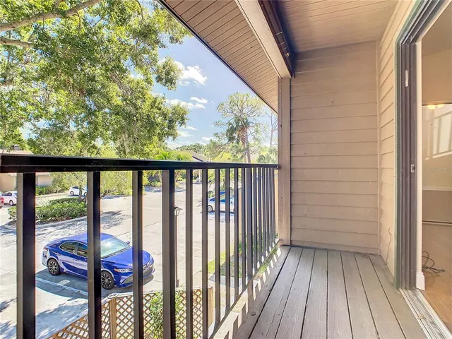 a view of a porch with wooden floor and outdoor space