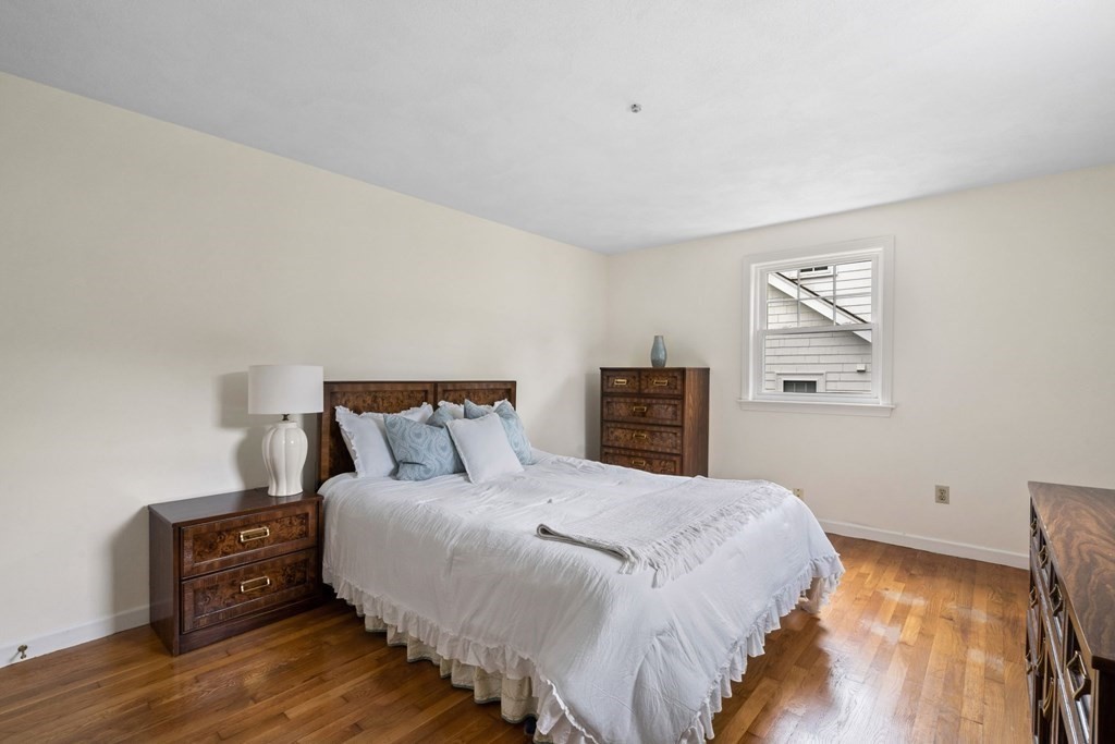 12 Lansdowne Road Arlington, MA 02474 - Photo 15 of 26 a bed sitting in a bedroom and night stand