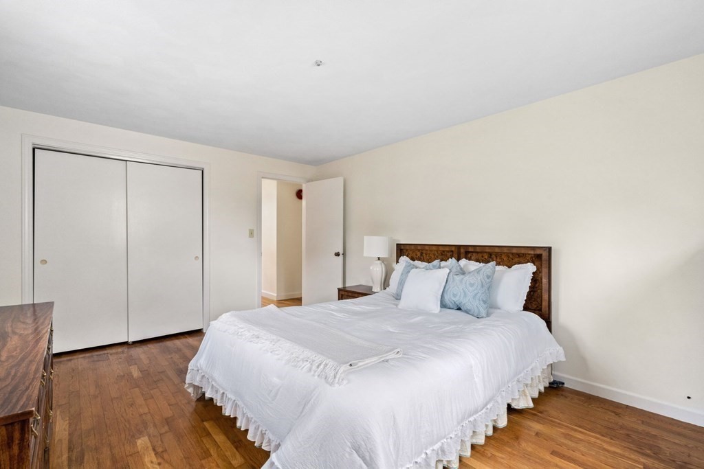 12 Lansdowne Road Arlington, MA 02474 - Photo 16 of 26 a bedroom with a bed and wooden floor