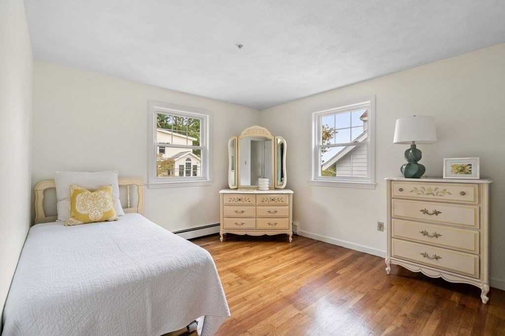 12 Lansdowne Road Arlington, MA 02474 - Photo 18 of 26 a bedroom with a bed and wooden floor