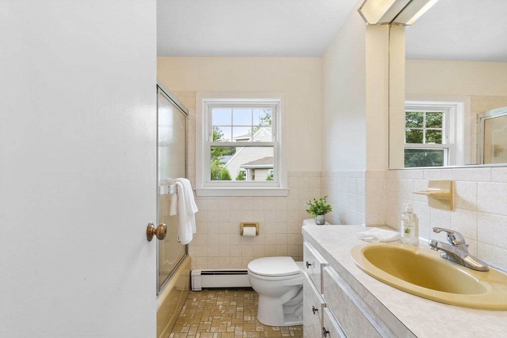12 Lansdowne Road Arlington, MA 02474 - Photo 20 of 26 a bathroom with a sink a toilet and a mirror