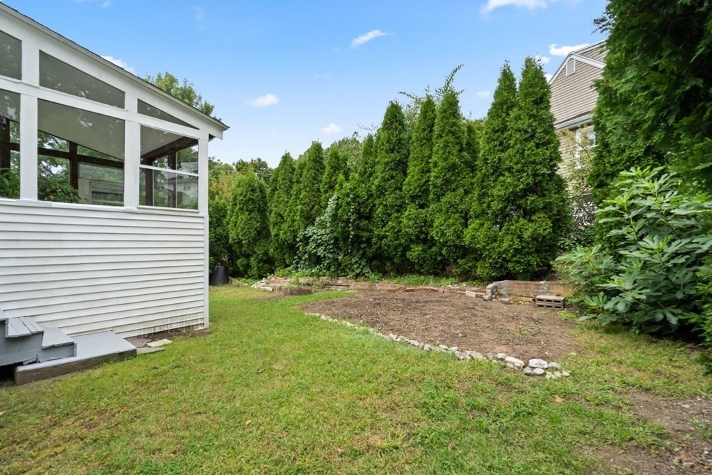 12 Lansdowne Road Arlington, MA 02474 - Photo 23 of 26 a view of a backyard with large trees and plants