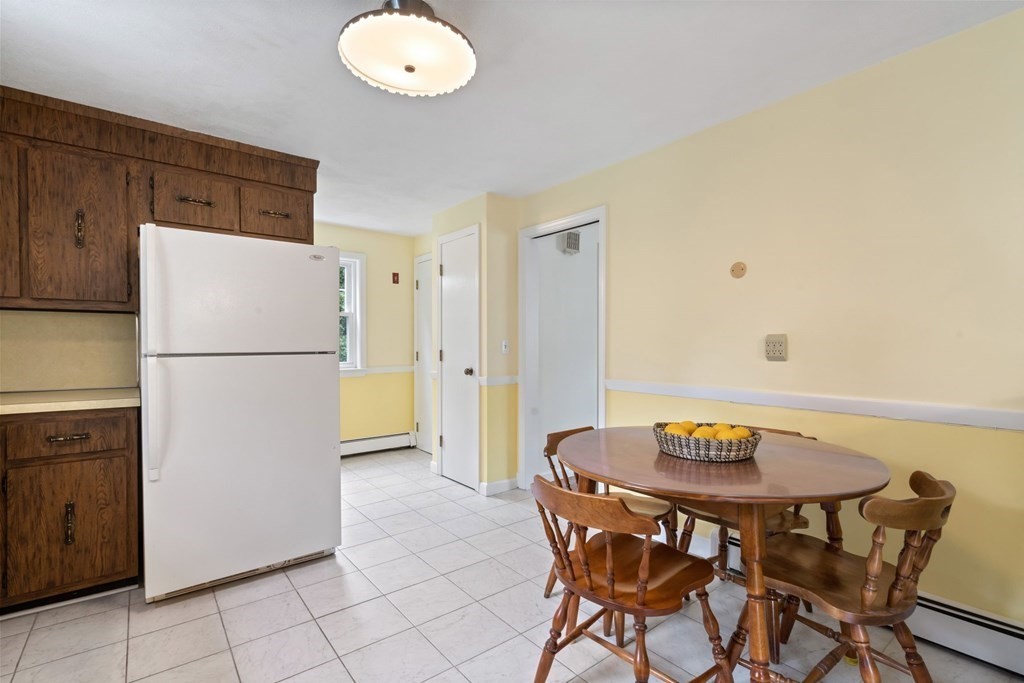 12 Lansdowne Road Arlington, MA 02474 - Photo 9 of 26 a kitchen with a refrigerator and table