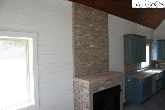 a kitchen with granite countertop white cabinets and a stove